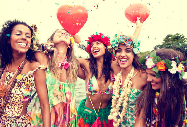 Mulheres vestidas com fantasias de carnaval se divertindo