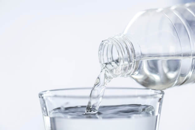 garrafa de água enchendo um copo