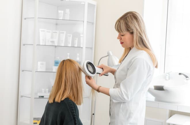 medica verificando cabelos da paciente