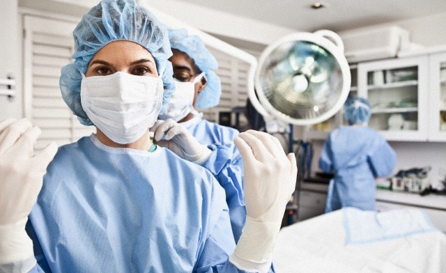 Surgeons preparing for operation in hospital --- Image by © Drew Myers/Corbis